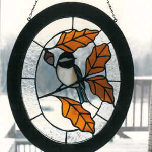 Stained Glass Sun catcher Showing Chickadee with fall leaves and acorn