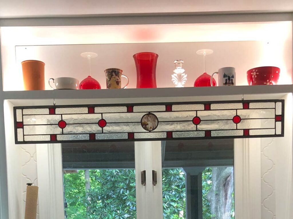 Stained Glass Alphonse Mucha window in red and textured clear glass