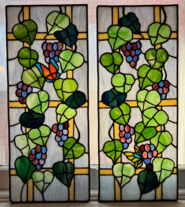 Photo of stained glass cabinet doors with grapevines and butterfly